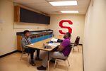 Dwight Roberson talks with El, a junior, at South Salem High School in Salem, Ore., Tuesday, Sept. 17, 2019. Community resource specialists like Roberson help student groups achieve academic success with one-on-one support.