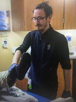 Tyler Cox at his job at Oregon Health & Science University, where he works as a nurse.