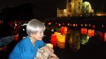Dr. Hideko Tamura Snider lights a peace lantern in Hiroshima on the 70th anniversary of the Hiroshima bombing.