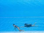 Team USA coach Andrea Fuentes swims toward Anita Alvarez, who sank to the bottom of the pool Wednesday during the women's solo free artistic swimming finals at the Budapest 2022 World Aquatics Championships.
