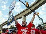 Members of the United Auto Workers (UAW) union march through the streets of downtown Detroit following a rally on the first day of the UAW strike in Detroit, Michigan, on September 15, 2023. Workers at the "Big Three" US auto manufacturers went on strike on September 15, 2023.