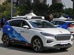 Baidu Apollo Robotaxis travels through a Beijing street on May 2.  Chinese tech giant Baidu has rolled out its driverless paid taxi service, making it the first company to market autonomous driving operations in China.
