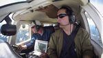 Jeff Lewis (left) listens for signals from below his airplane indicating the presence of fishers below in the Gifford Pinchot National Forest.
