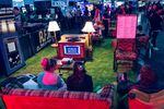A group of people sit on couches and chairs at the Portland Retro gaming Expo.