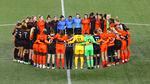 National Women's Soccer league players form a circle on the pitch at Providence Park in Portland.