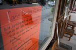 A sign declares Covid Dining Rules at a cafe in Prairie City, Oregon: "We do not like any of this either."