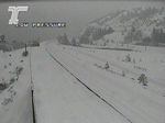 A traffic cam screen shot shows a road blanketed in snow.