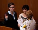 Newly-elected House Speaker Tina Kotek left, is sworn in by former Oregon Gov. Barbara Roberts, right, while Kotek's partner Aimee Wilson watches as the Oregon Legislature convenes in Salem, Ore., Monday, Jan. 14, 2013.  