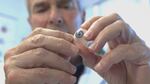 Ocularist Fred Harwin holds a prosthetic eye he's hand-painted for a patient.