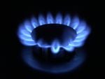 A blue flame burns on a natural gas stove.