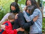 Kennedy Garrett, 24, center, is comforted by her sister, right, and family members after speaking about her father, Robert Delgado of Portland, who was killed by Portland Police in Lents Park earlier in the month.