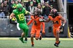 Oregon tight end Terrance Ferguson (19) runs after catching a pass as Oregon State defensive back Jaydon Grant (3) and Oregon State linebacker Avery Roberts (34) pursue during the third quarter of an NCAA college football game Saturday, Nov. 27, 2021, in Eugene, Ore.