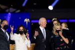 President-elect Joe Biden, his wife Jill Biden, and members of the Biden family, along with Vice President-elect Kamala Harris, her husband Doug Emhoff stand on stage Saturday, Nov. 7, 2020, in Wilmington, Del.