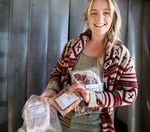 Cate Havstad-Casad holds frozen meat produced by her family farm in Jefferson County. After years of specializing in organic vegetables, water shortages are driving Havstad-Casad and her husband to make a costly shift to grazing and meat production, she said. May 11, 2022.