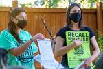 Organizers in the effort to recall Portland Mayor Ted Wheeler, Anisa Pollard, left, and Audrey Caines, right, instruct volunteers how to gather signatures for a recall petition in Portland July 8, 2021 in Portland. 