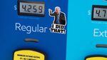 A gas pump displays current fuel prices, along with a sticker of President Biden, at a gas station in Arlington, Va., on March 16. The sticker says "I did that" — but the president wasn't responsible for rising prices then or falling prices now.