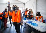 Gov. Kate Brown thanks workers drawing up COVID-19 vaccines as she tours a drive-thru vaccination clinic at Portland International Airport, April 9, 2021. Now a lawsuit seeks to overturn the governor's vaccine mandate.
