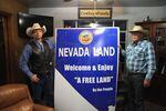 Ryan Bundy, left, and Cliven Bundy hold up a sign in their living room. Ryan Bundy is running for governor as a next step in the family's fight to remove the federal government from Nevada.