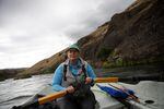 Fishing guide Amy Hazel rows a drift boat on the lower Deschutes River near Maupin, Ore., June 17, 2022. She's been guiding on the river since 1999.