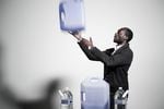 Digital service product owner Tolu Adedipe keeps his eye on making sure his 14 gallons of water are properly secured, up-to-date and stored.