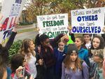 Oregon City High School students carried signs to the sidewalk next to the school after a meeting inside, about recently-circulated racist messages at the school.