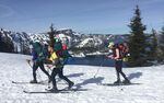 The crew sets off around Crater Lake by ski. Wizard Island is visible in the background.