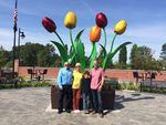 Sculptor Dave Frei and the Blackburn family with "Tulip Dance" in Mt. Vernon, Washington