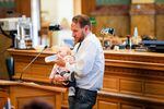 Democratic state Rep. Chris Kennedy feeds his baby daughter Lennon while speaking to lawmakers on the House floor, Friday, April 22, 2022.