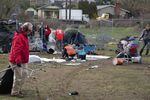 FILE: People clean up as the Peninsula Crossing trail homeless camp in Portland is swept. Feb. 8, 2023.