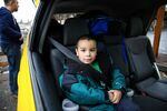 Michael Bunch, 4, sits in a car on what was moving day for his family. Until then, Michael had never had a home of his own.