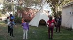 Acosia Red Elk teaching a powwow dance class in her backyard.