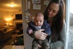 Vancouver, Wash. resident Megan Jasurda holds her 11-week old son, Tristan. During the measles outbreak, she hasn’t left the house with Tristan, who is too young to be vaccinated.