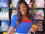 Chanée Hill, dressed in an homage to Donald Duck, in a room in her house lined with displays of hundreds of dollars' worth of Disney merchandise.