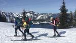 The crew sets off around Crater Lake by ski. Wizard Island is visible in the background.