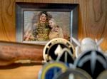 A photo of Joe Kent, left, and his late wife Shannon, a Navy cryptologist who was killed in action in 2019, sits on the shelf in Kent’s home office in Yacolt, Wash., Sept. 29, 2021. Kent, a Republican, is challenging Rep. Jaime Herrera Beutler for Washington’s 3rd Congressional District.