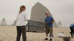 Valerie Schockelt (left) and Marc Ward use a microplastics filtration device to filter sand at Cannon Beach with iconic Haystack Rock in the background.