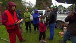 High school student Bailey Schaecher (in orange vest) leads a Friends of Trees planting crew on a rainy Saturday in North Portland.