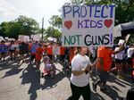 FILE - Family and friends of those killed and injured in the school shootings at Robb Elementary take part in a protest march and rally, Sunday, July 10, 2022, in Uvalde, Texas.