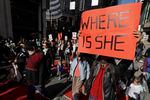 FILE - Dennis Willard, of Bellevue, Wash., carries a sign that reads "Where Is She" as he marches in support of missing and murdered indigenous women during a rally to mark Indigenous Peoples' Day in downtown Seattle, on Oct. 14, 2019. Washington Gov. Jay Inslee has signed into law a bill that creates a first-in-the-nation statewide alert system for missing Indigenous people. The law creates a system similar to Amber Alerts and so-called silver alerts, which are used respectively for missing children and vulnerable adults in many states.