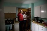 Sara and Ed Johnson shine a flashlight in their pantry to see what they can make for their first "Living Off Your Quake Kit" dinner. The Johnsons have a flashlight in each room of their house.
