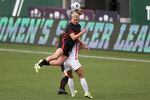 Portland Thorn's Lindsey Horan (10) jumps over OL Reign's Angelina (26) for a header during an NWSL Challenge Cup soccer match, in this file photo on Wednesday, April 21, 2021, in Portland, Ore. Thorns midfielder Lindsey Horan has been loaned to French club Lyon through the summer of 2023.