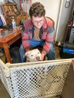 Class of 2025 student Austin plays with his dog in his parents' auto shop in Portland, Ore. on March 30, 2022. Last year, Austin would spend time with the family dogs after he was done with his virtual classes. He attended David Douglas Online Academy last year, an online-only program.