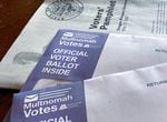 An OPB file photo of Multnomah County ballot envelopes and a voters’ pamphlet. 