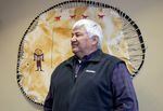 Confederated Tribes of Warm Springs CEO Robert "Bobby" Brunoe stands in front of a deerskin artwork by Wasco Chief Nelson Wallulatum. November 3, 2023.