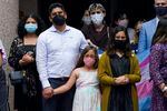 Supporters of transgender rights gather in Texas, all wearing masks to cover their mouths and noses.