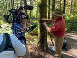 Jim Fitzgerald sets up his hand made large format camera in the woods near Lucia Falls