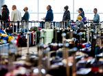 Travelers wait in line before they are allowed to search for their luggage in a baggage holding area for Southwest Airlines at Denver International Airport on December 28, 2022 in Denver, Colorado.