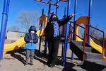 Angel, 6, and his mother Angelica Rodriguez walk in a playground in front of their house on Wednesday, Dec. 23, 2020, in Santa Fe, N.M. Rodriguez pointed to a park that's closed due to virus restrictions. Rodriguez and her husband, both cooks, struggled to pay rent this year as their hours were cut in half.