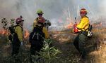 Trainees and personnel gather on the edge of an 8-acre burn on the Andrew Reasoner Wildlife Preserve on Oct. 16, 2021.