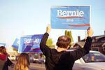 Bernie Sanders fans wave signs outside the new Bernie Sanders campaign headquarters in Portland, Ore., April 6, 2016.